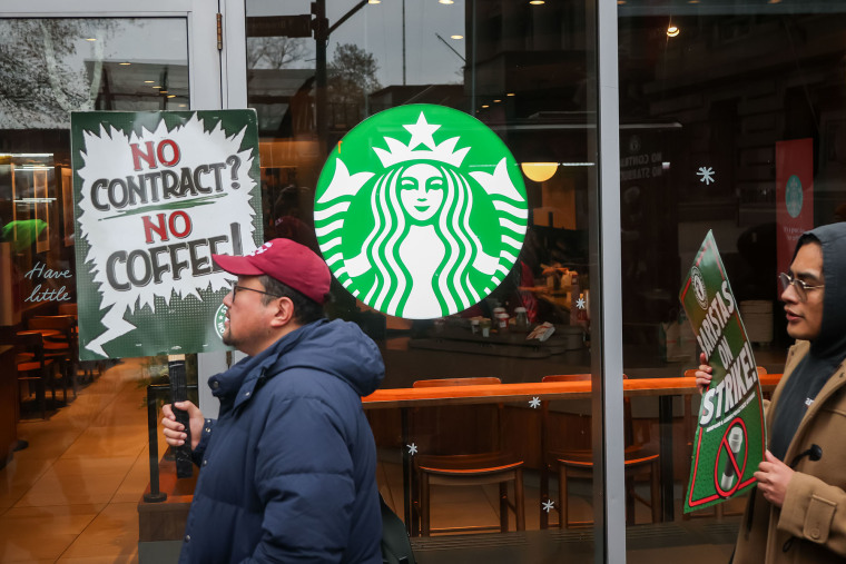 Starbucks Workers United members and supporters picket outside a Starbucks store in New York on Nov. 21, 2025.